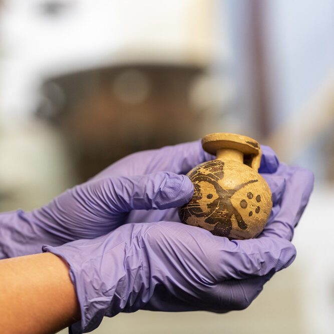 Corinthian ball aryballos (ca. 575 BCE) held in the palm of a hand
Reading, Ure Museum 37.11.2